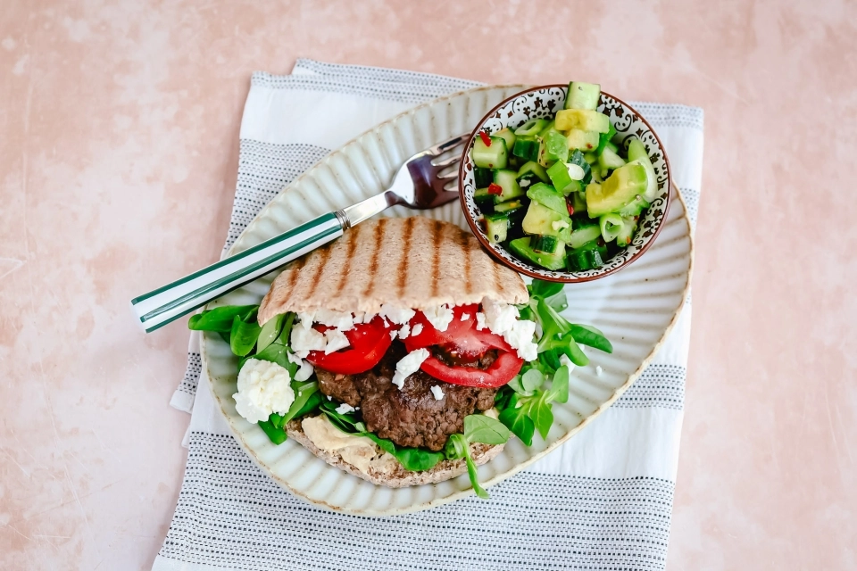 Pita burger with feta & avocado-cucumber salad